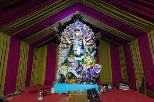 Free Colorful statue of Goddess Durga during a vibrant Indian festival indoors. Stock Photo