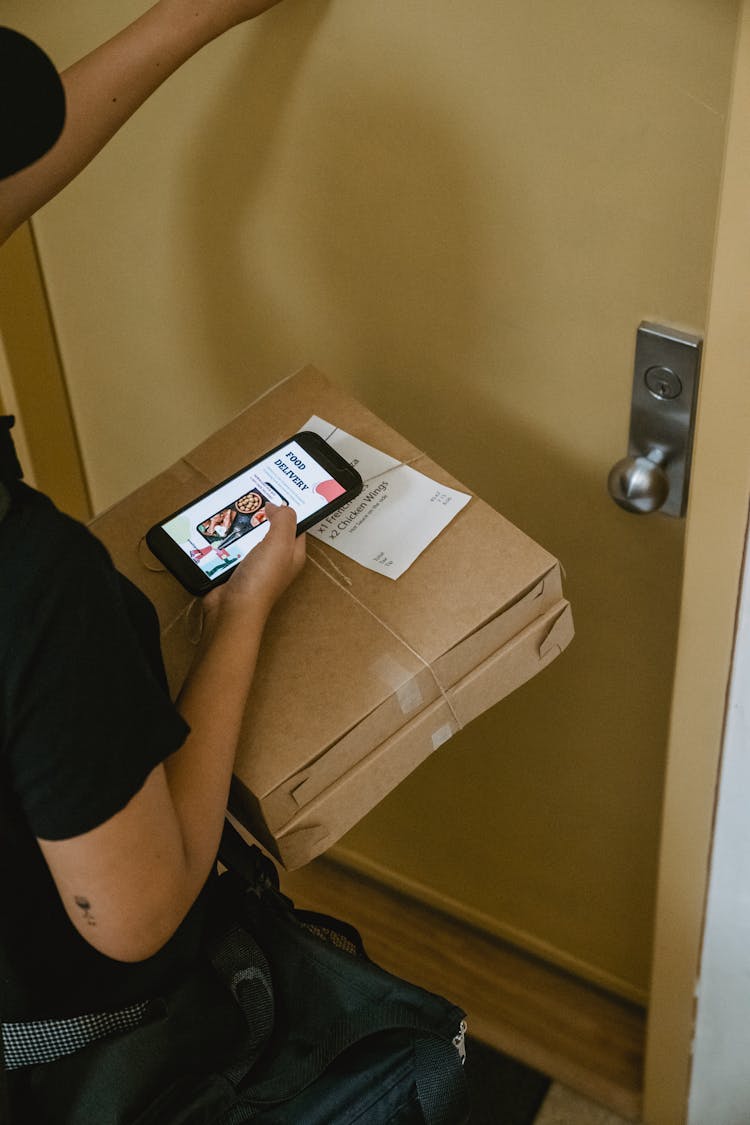 A Person Knocking On The Door For A Food Delivery