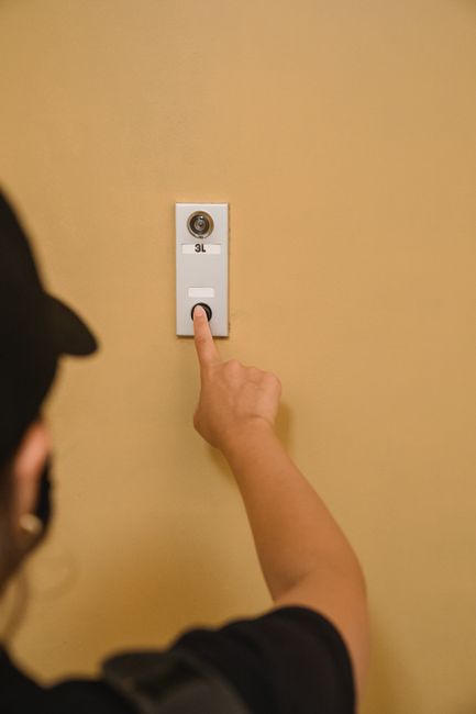 hand pressing emergency intercom on train