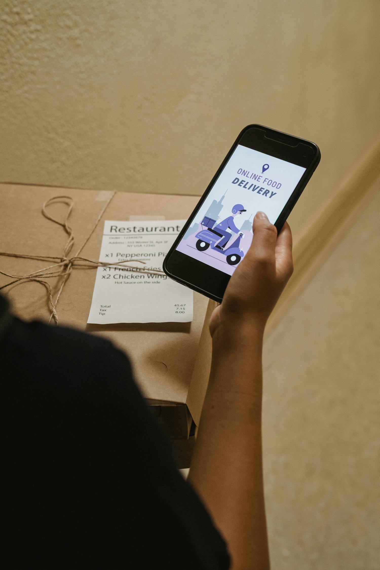 Person holding a phone displaying an online food delivery app