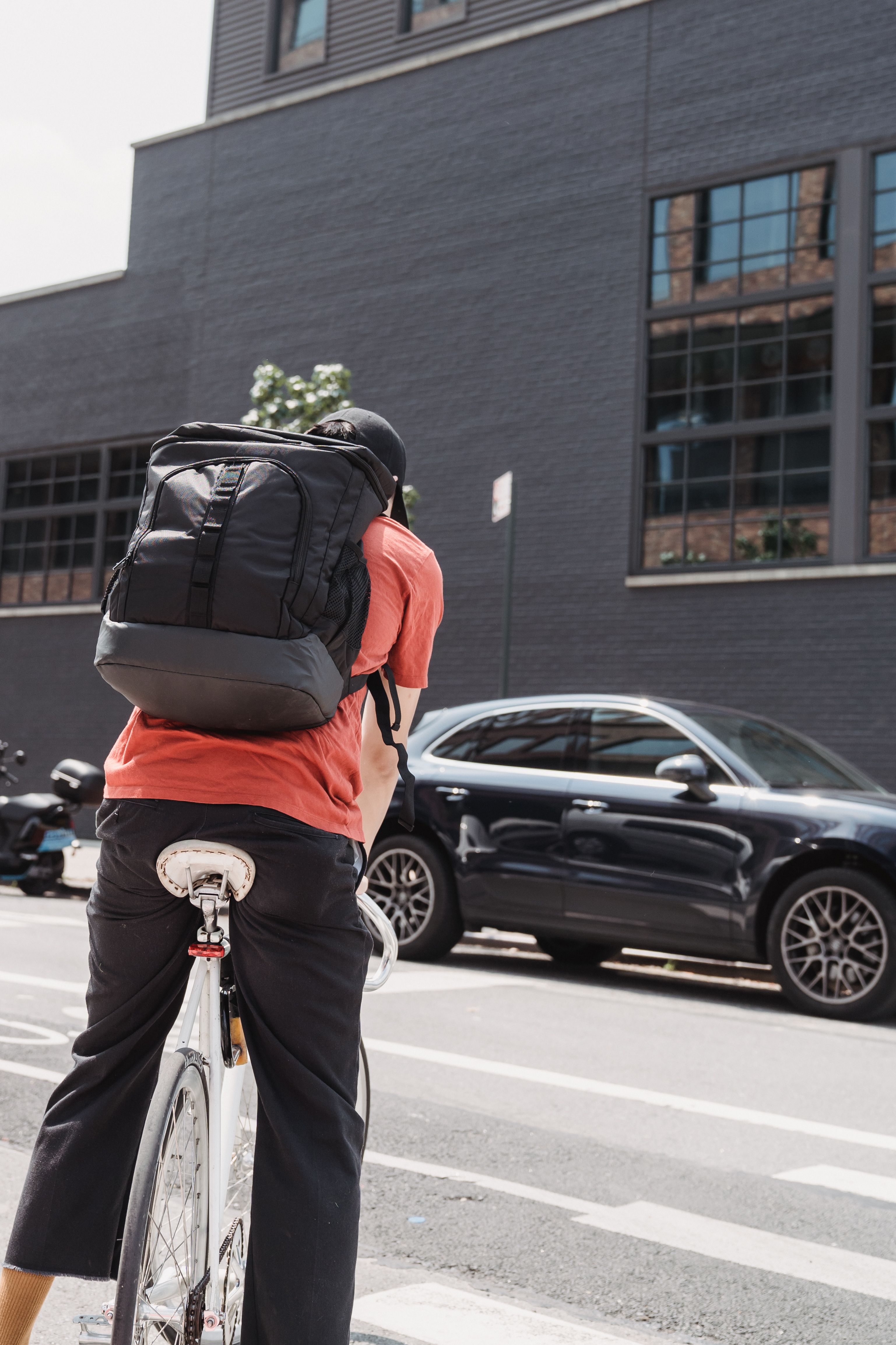 City commuter wearing a wholesale laptop backpack
