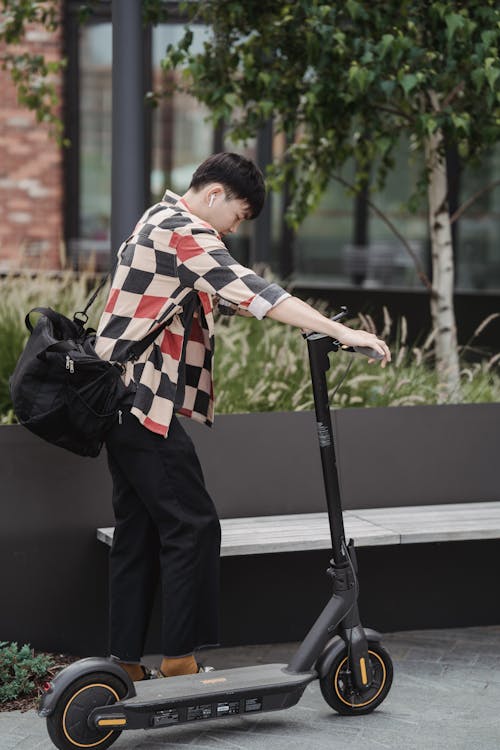 Man is parking his Ninebot Max electric scooter.