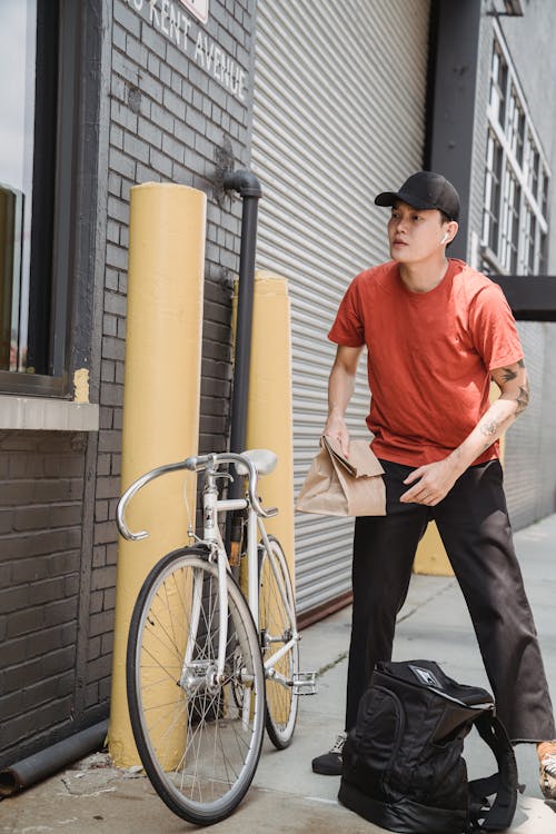A Deliveryman Holding a Paper Bag