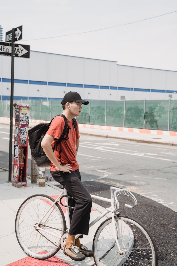 Man On Bicycle Waiting On Crossroad