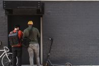 Couriers in Front of a Brick Walled Building