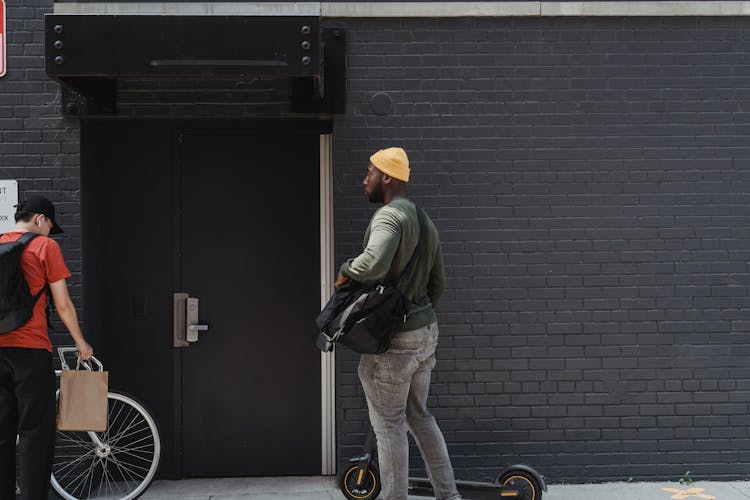 Couriers In Front Of A Brick Walled Building