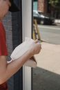 Person in Red T-shirt Holding White Paper