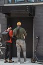 Couriers in Front of a Building Entrance