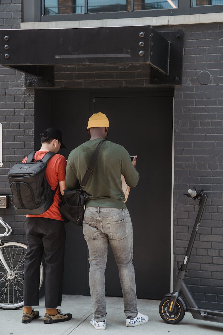 Couriers In Front Of A Building Entrance