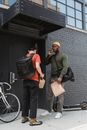 Couriers in Front of a Building Entrance