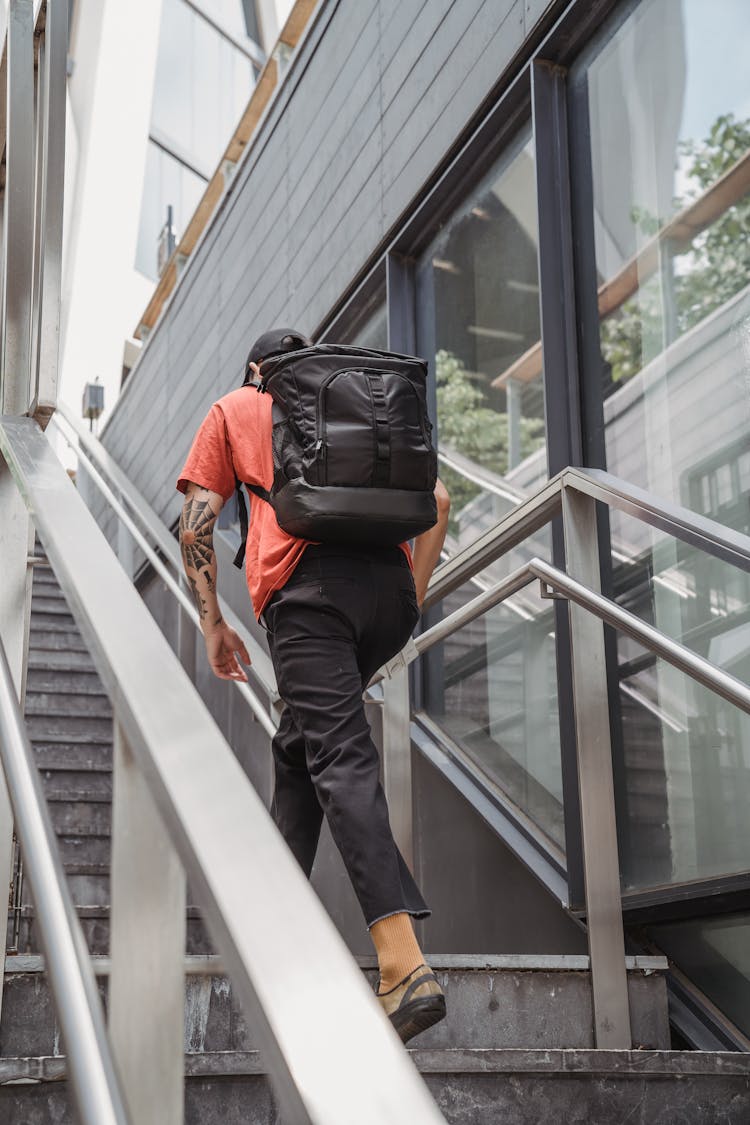 Delivery Man With Backpack Ascending Stairs