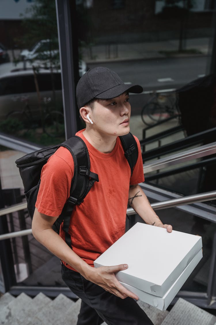 A Man Carrying Two Boxes