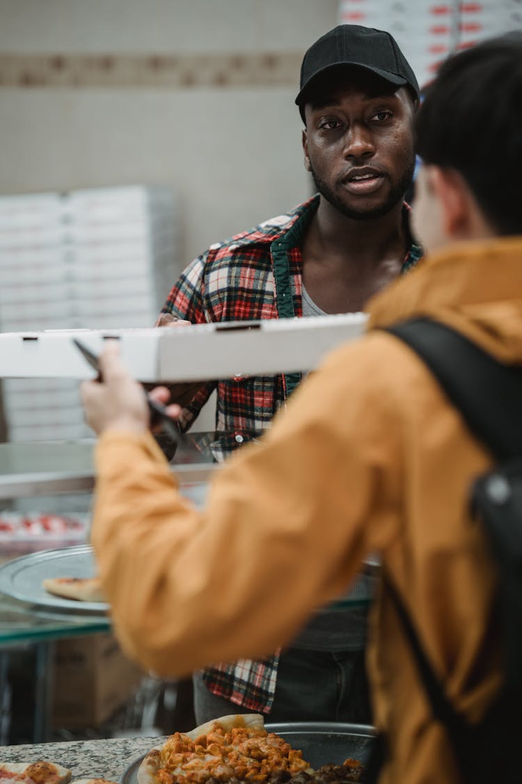 A Man Working In A Pizza Parlor