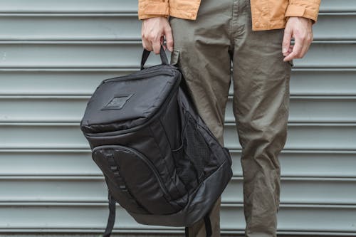 Free Person in Brown Jacket and Gray Pants Carrying Black Backpack Stock Photo