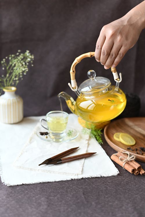 Pouring Lemon Tea in a Glass Cup