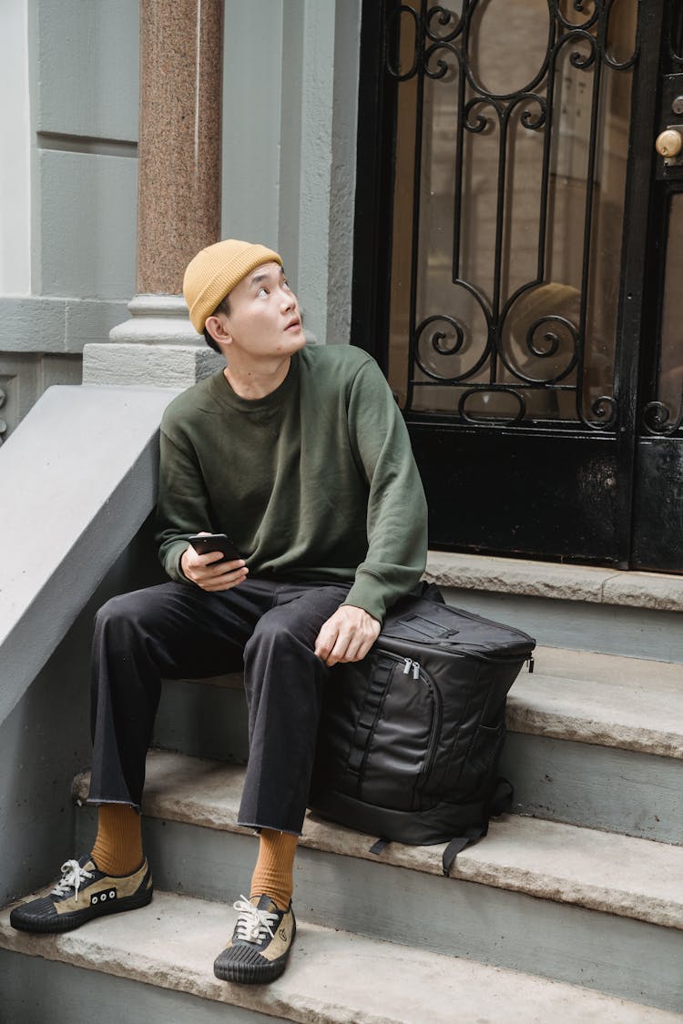 A Stylish Man Sitting On The Front Steps