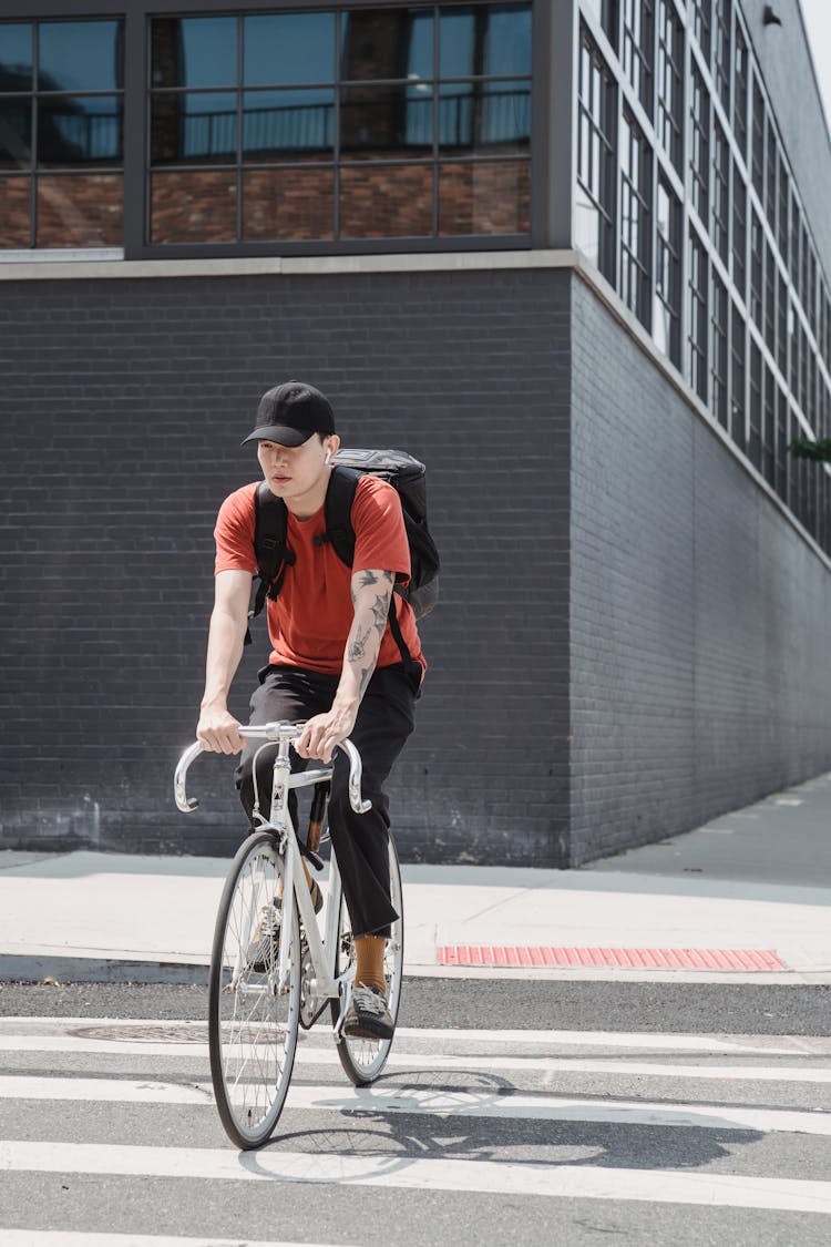 A Man On A Bicycle In A City