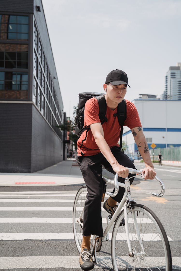 A Delivery Man Riding A Bicycle