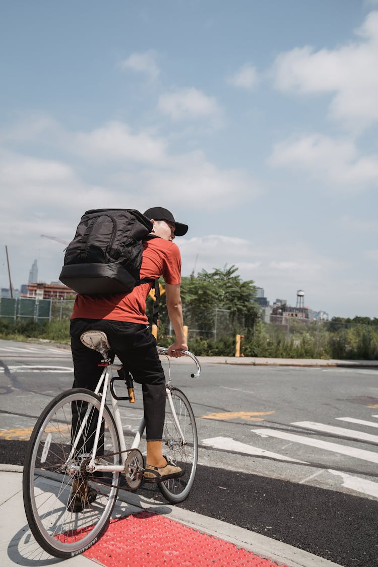 Man With Backpack On Bicycle