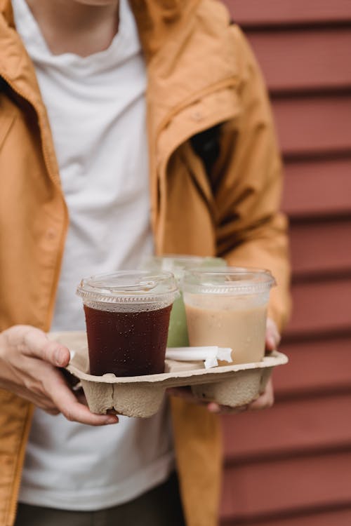 Man Holding Cardboard Tray of Takeout Drinks