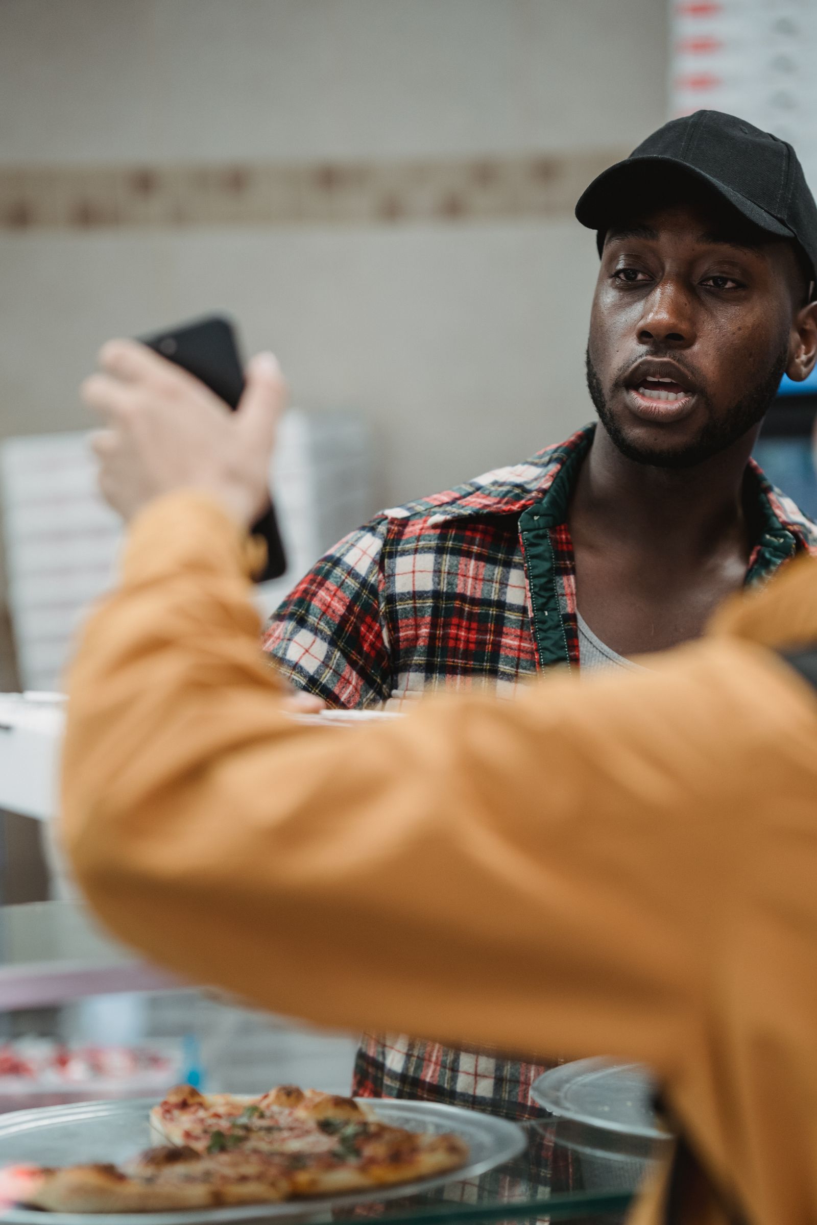 African customer ordering food at a restaurant counter