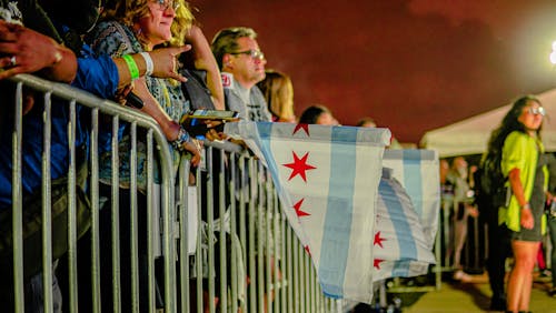 People in the Front Row at a Concert Holding City of Chicago Flag, Illinois, United States