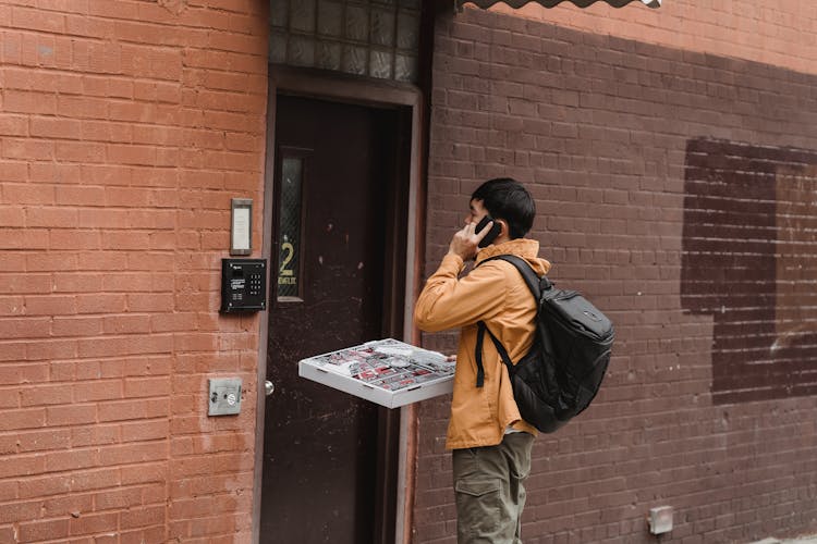 Man Standing Beside A Door