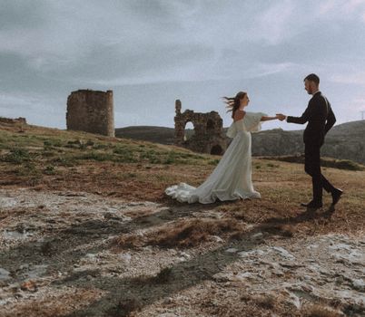 Couple dancing in historic ruins, capturing love and timeless beauty.