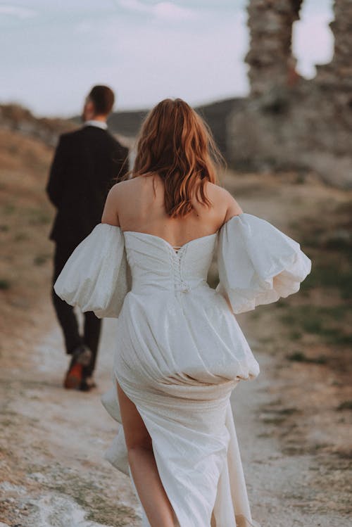 A Couple Walking on Brown Field