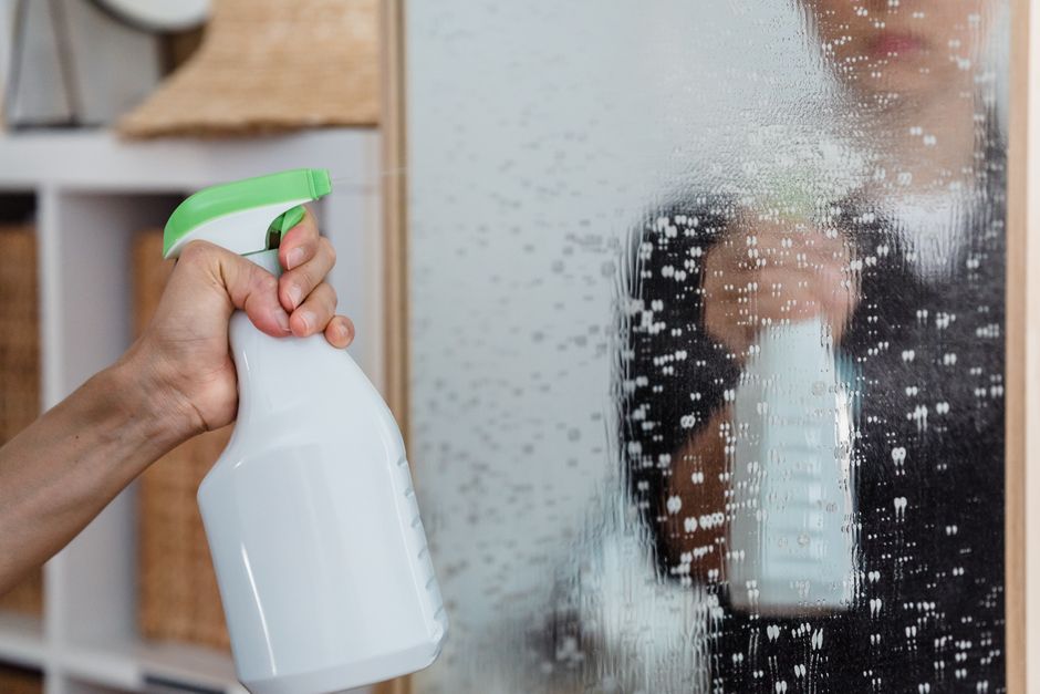 Photo by Liliana Drew on Pexels Close-up of a hand using a spray bottle to clean a mirror indoors. - Photo by Liliana Drew on Pexels