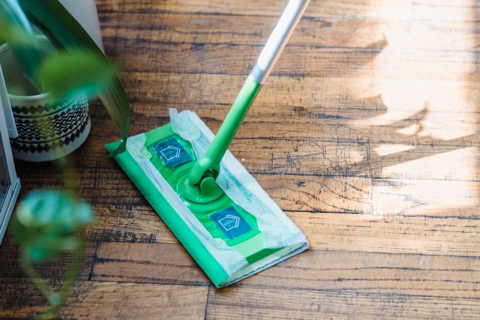 Cleaning a wood floor with a mop — stock photo