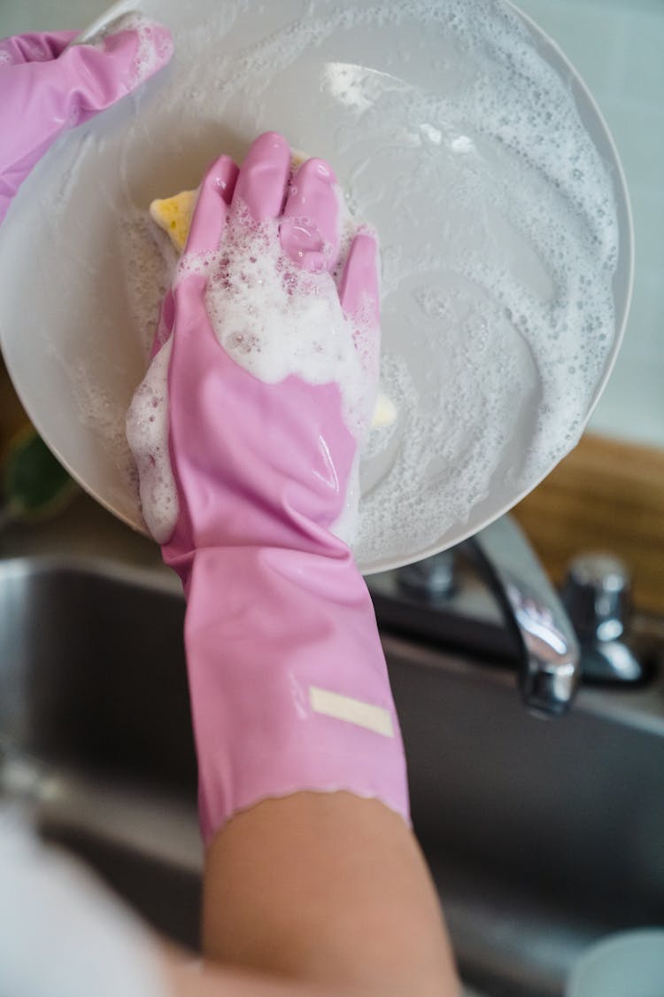 A Person Washing A Plate