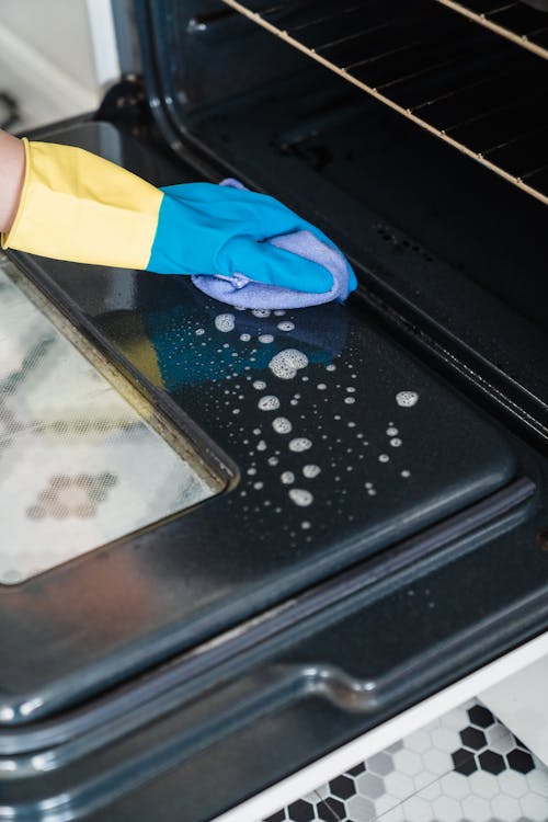 A Person Cleaning an Oven