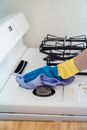 A Person Cleaning a Gas Stove