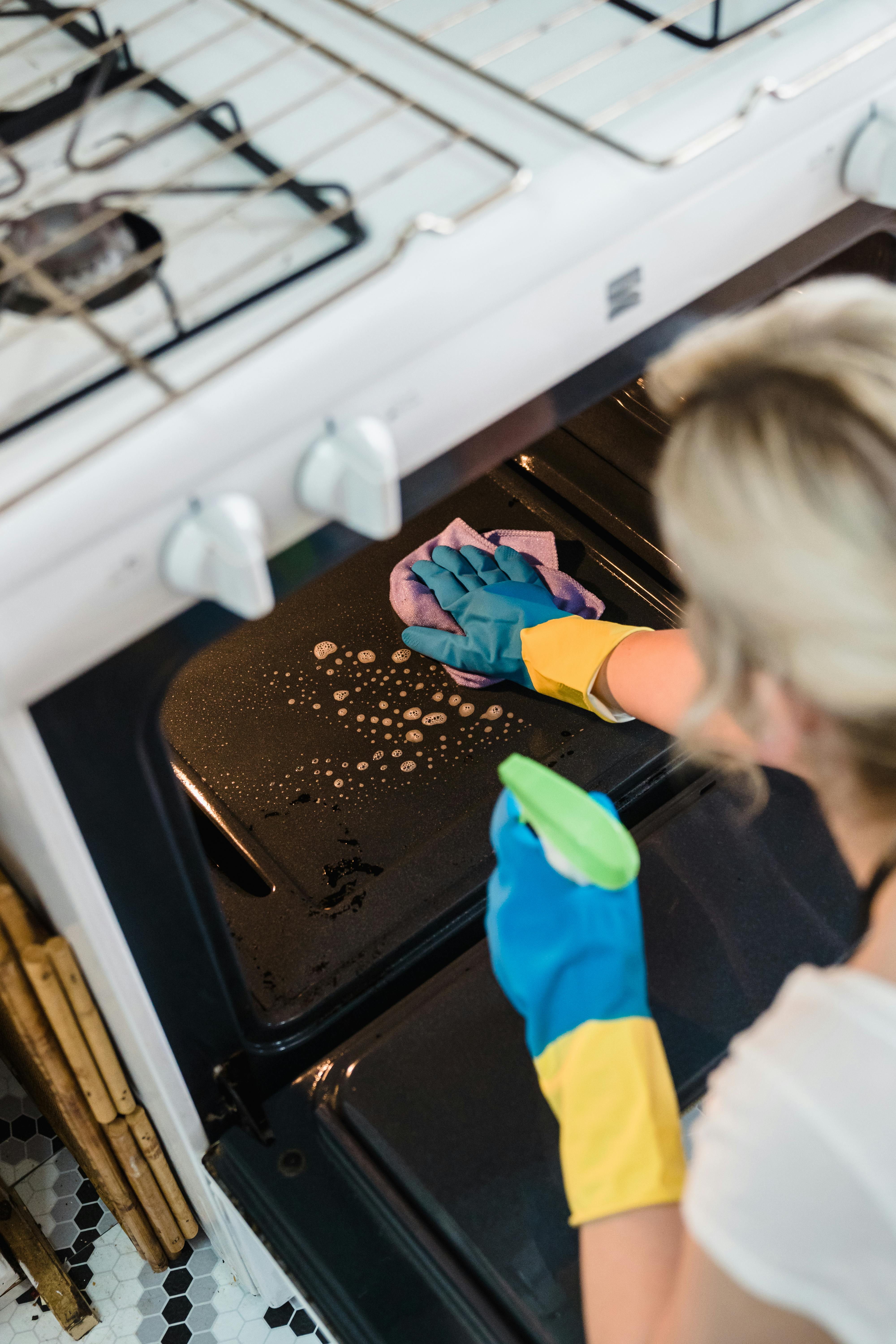 a woman cleaning the oven