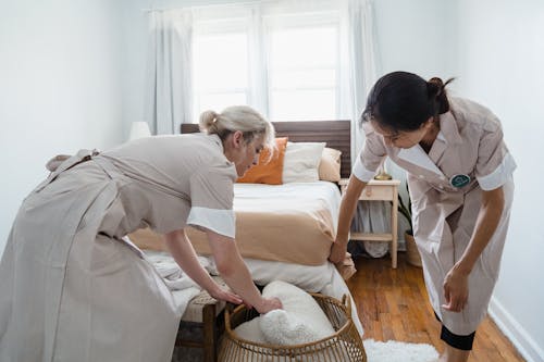 Free Women Cleaning the Bedroom Stock Photo