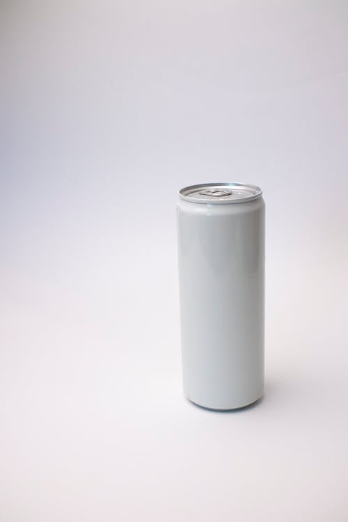 Close Up Photo of Can on White Surface