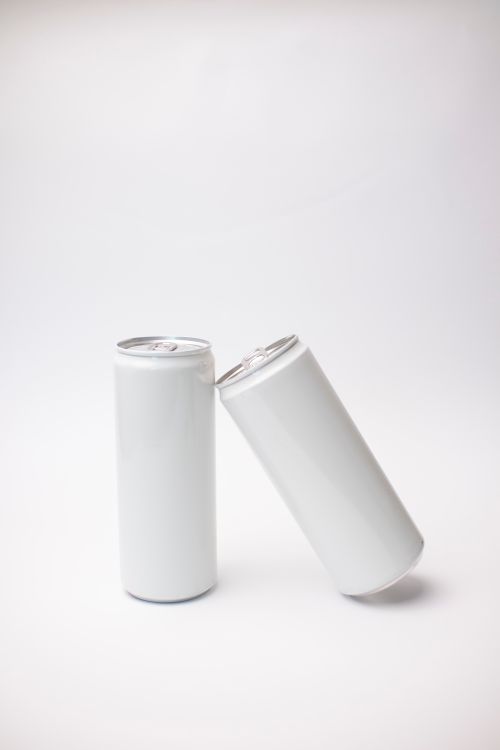 Free Minimal mockup of two white soda cans against a plain background, ideal for product display. Stock Photo