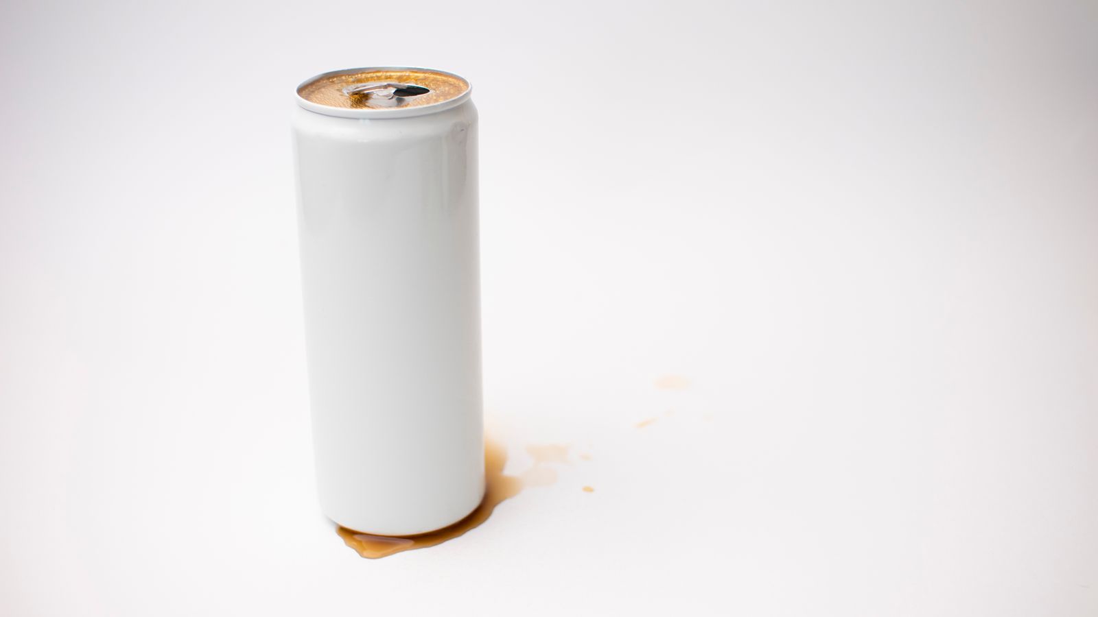 A spilled beverage can with liquid on a minimalist white background.
