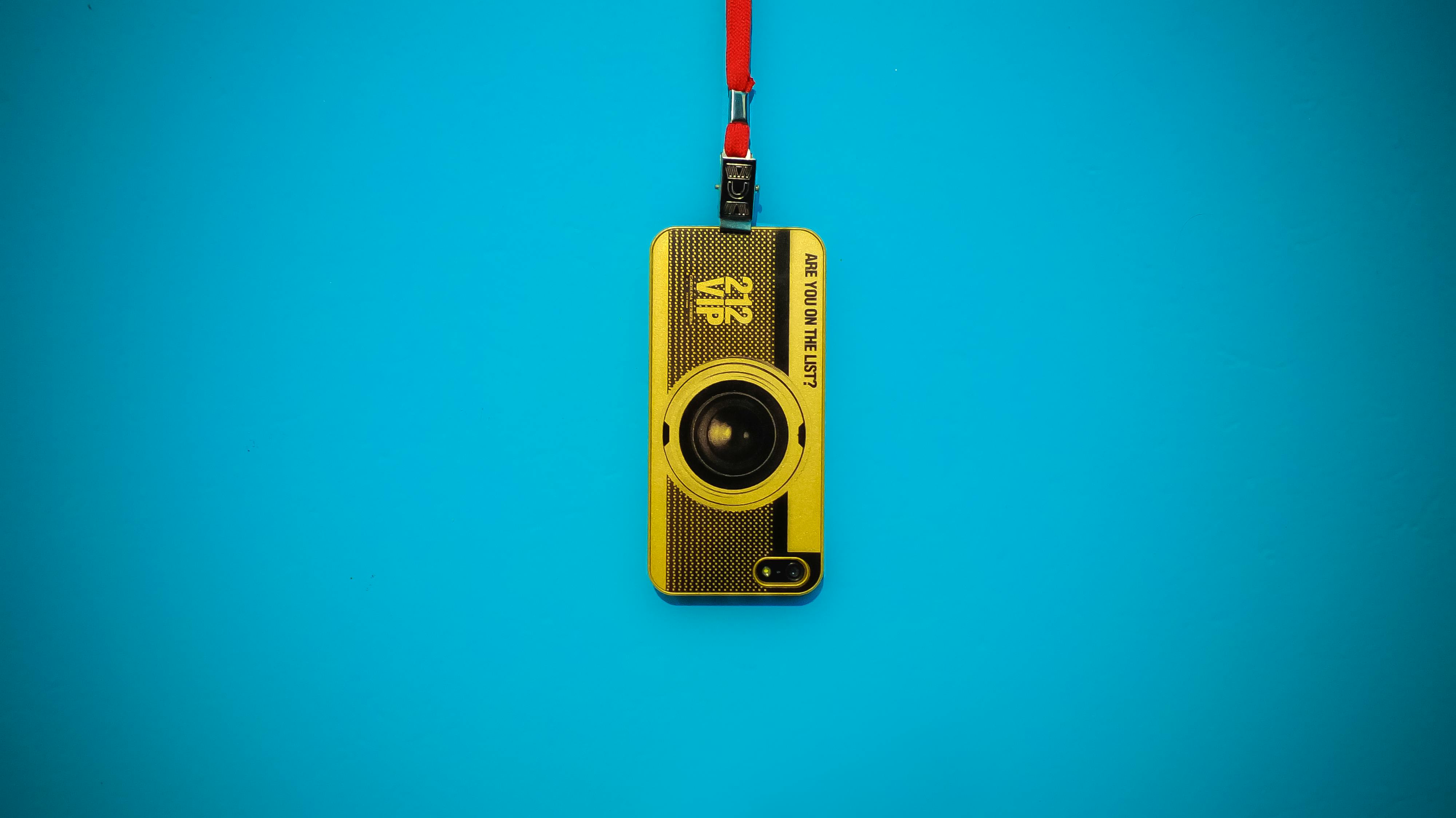 Yellow 212 Vip Camera Hanging on Blue Wall