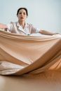Woman Putting Bedsheet in a Bed