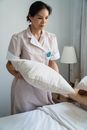 Housekeeper Holding a Pillow