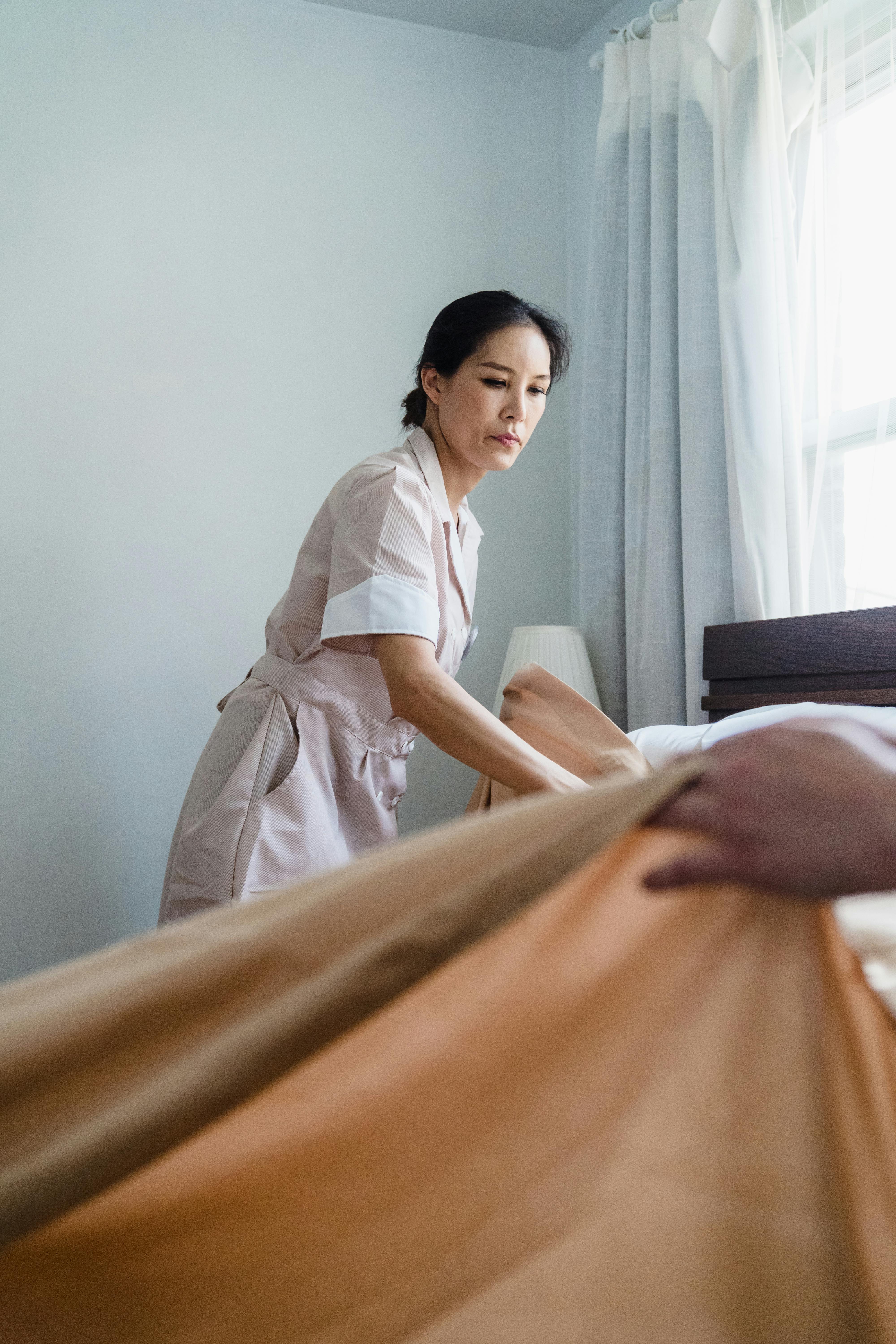 a woman fixing the bed