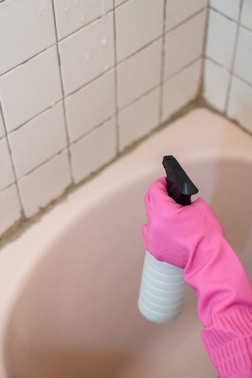 Person Spraying a Tiles