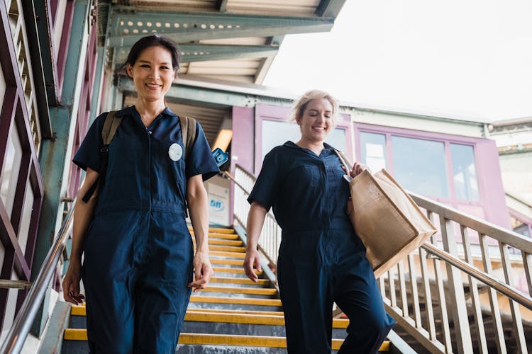 Two Women Walking Down The Stairs