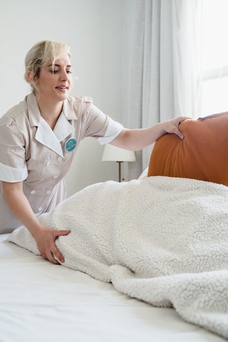 A Woman Making The Bed