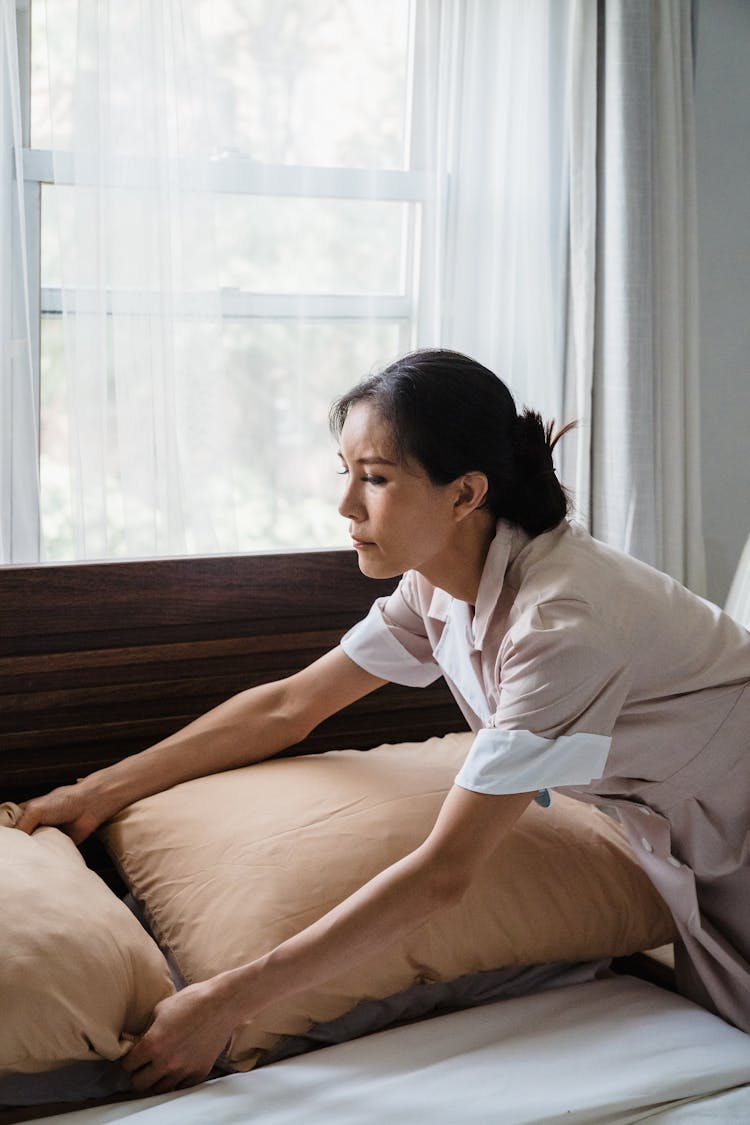 Woman Cleaning Bedroom