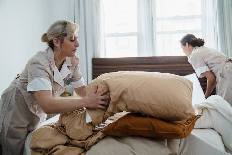 Two Women Making The Bed