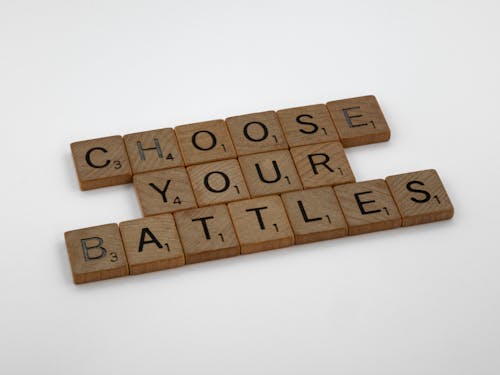 Brown Wooden Scrabble Tiles on White Table