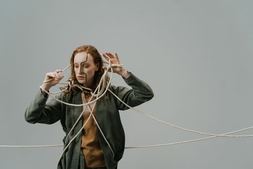 Free A woman entangled in ropes, expressing emotions and concepts like stress or entrapment. Stock Photo
